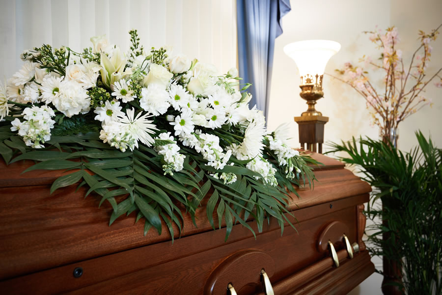Casket with white flowers on top
